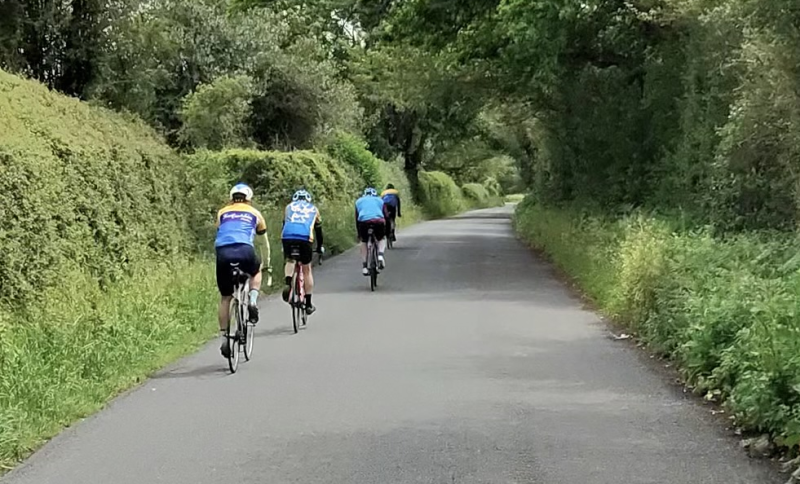 Image of Category 3 riders on verdant lanes